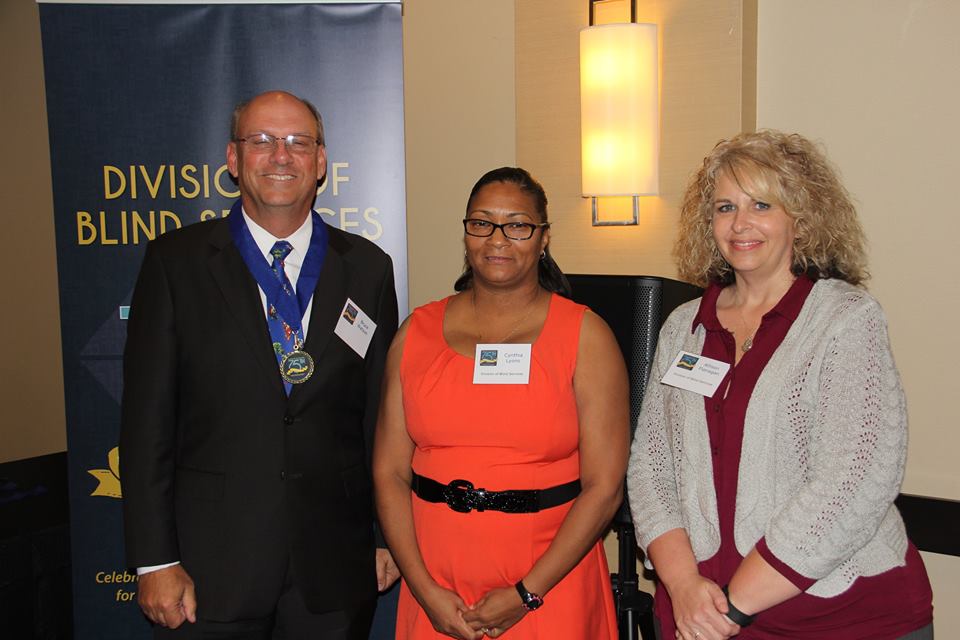 Bruce Watson of Early Learning Coalition of Escambia standing with DBS staff members Allison Flannigan and Cynthia Lyons during the Successful 75 Award presentation. 